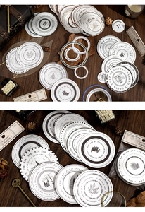 Detail of vintage round stickers with floral and calendar designs on dark wood background