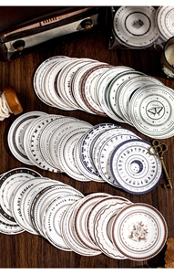 Macro detail of vintage round planner stickers with retro designs on wood background