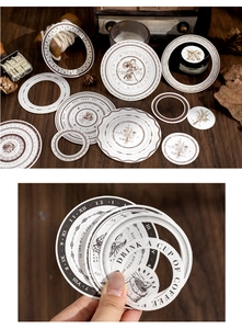 Close-up of vintage round stickers with floral and clock patterns for journaling