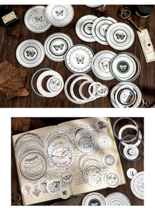 Detailed view of vintage circular stickers with butterflies and lunar phases on old book pages