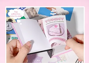 Close-up of pink vintage scrapbook paper with top glue binding and dessert motifs