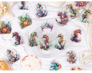 Macro detail of PET ocean stickers featuring seahorses and anchors on white background