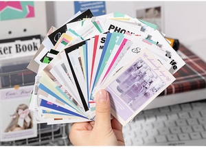 Close-up of vintage aesthetic scrapbook stickers with floral and retro designs in hand