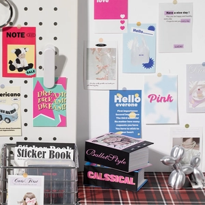 Retro aesthetic scrapbook kit with vintage books and balloon dog decor on grid board