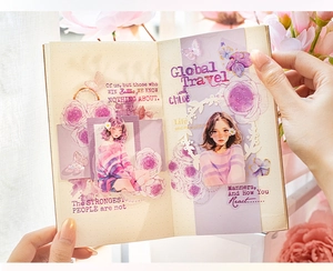 Detail of PET girl character stickers and purple floral motifs on a bullet journal page