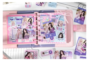 Macro view of pink anime girl stickers and binder pages for DIY scrapbooking