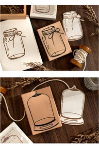 Macro view of vintage wooden rubber stamps featuring bottle and glass bell jar designs