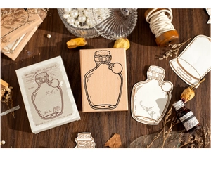Macro shot of vintage wooden stamp with glass bottle illustration and retro paper box