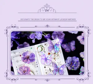 Macro shot of purple holographic butterfly and floral stickers for journaling decorations