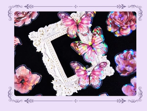 Close-up of holographic laser butterfly and flower stickers with shell light effect