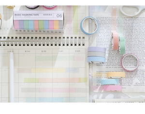 Macro detail of macaron colored grid washi tape rolls for creative journaling scrapbooks