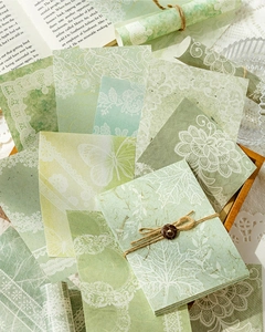 Vintage-Scrapbooking-Papier in Grün mit Spitzen- und Schmetterlingsmotiven auf Holz