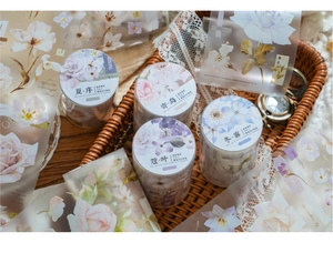 Detailed macro view of forest floral PET tape roll with vintage props and lace