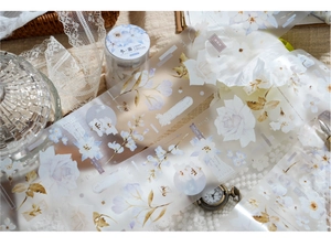 Artistic detail of PET floral tape with lilies and roses in a vintage scrapbooking setup