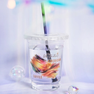 Artistic clear coffee cup with watercolor print and lid for creative beverage presentation