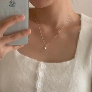 Close-up of 925 sterling silver heart pendant with frosted finish on a delicate chain