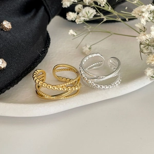 Minimalist S925 silver layered rings in gold and silver finish on a stylish display base