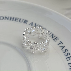 Macro shot of S925 sterling silver irregular flower ring with sparkling zircon stones