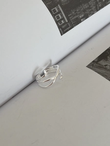 Détail d'une bague ouverte multicouche en argent S925 sur une page de magazine