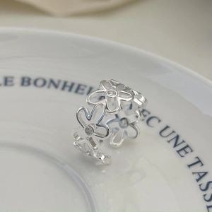 Macro view of S925 sterling silver daisy ring with sparkling cubic zirconia stones