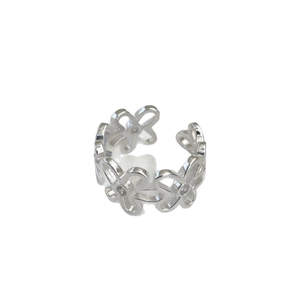 Irregular silver flower open ring with sparkling cubic zirconia on a white background