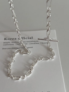 Macro shot of S925 sterling silver chain necklace featuring a classic T-bar OT toggle clasp