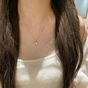Elegant gold S925 silver necklace with rectangular starburst pendant on model