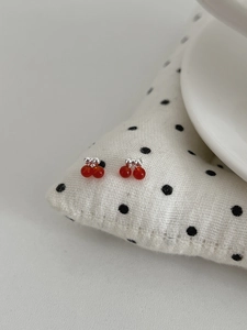 Detailed view of S925 silver cherry stud earrings with vibrant red gemstone beads
