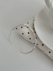 Close-up of hammered S925 sterling silver cuff bracelet with irregular liquid texture
