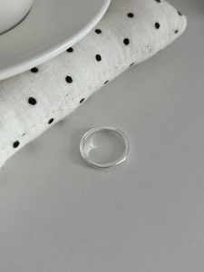 Close-up of S925 sterling silver stamp on minimalist polished band ring detail