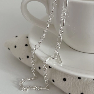 Minimalist S925 silver chain necklace with OT toggle clasp hanging on a ceramic cup