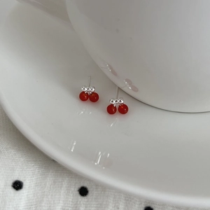 Elegant S925 silver cherry earrings with red beads and bowknot on white ceramic