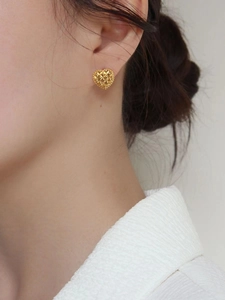 French vintage style 925 sterling silver heart earrings with textured golden finish on model