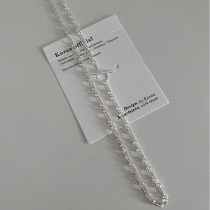 Minimalist S925 sterling silver OT buckle chain necklace displayed on brand card
