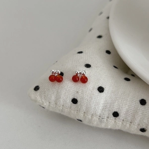 Minimalist S925 silver cherry stud earrings with red beads on a stylish dotted fabric