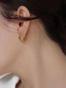 French vintage 925 silver heart hoop earring with embossed texture on a female model