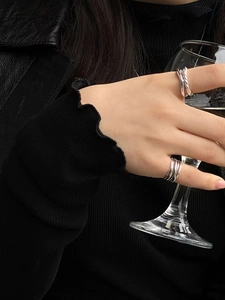 Close-up of minimalist S925 sterling silver knotted double-layer rings on hand