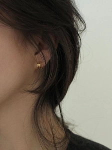 Close-up of minimalist 925 silver golden double C-shaped earrings on a model's ear