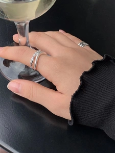 Minimalist 925 sterling silver knot ring set with layered double lines on model hand