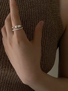 Minimalist 925 sterling silver open pearl ring set worn on model with knit background