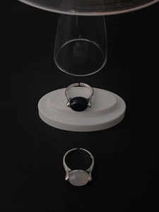 Detail of 925 silver open rings with black onyx and white natural stones on tray