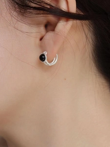 Detail view of S925 sterling silver hoop earrings with black bead and wire texture