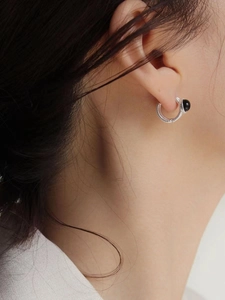 Detail of S925 sterling silver hoop earrings with spiral texture and black agate bead