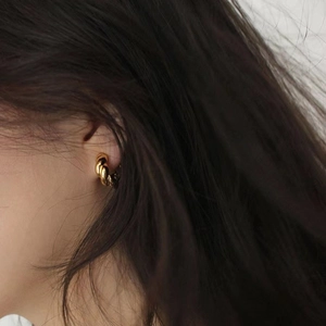 Elegant 925 sterling silver gold twisted hoop earrings worn on female model