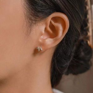 Minimalist silver balloon dog stud earrings with a polished mirror finish for women
