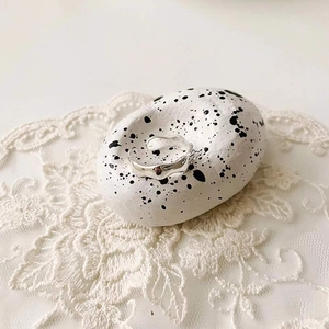 Irregular silver textured ring on stone and lace background showing unique lava design