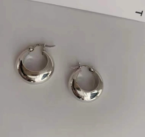 Macro shot of S925 sterling silver stamp on thick French style oval hoop earrings
