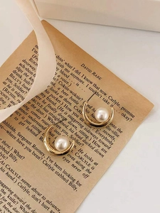 Minimalist S925 sterling silver crescent pearl earrings in golden finish on vintage paper