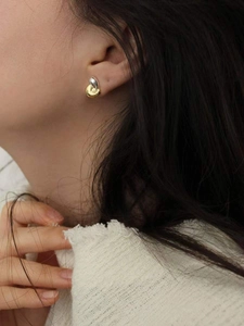 925 sterling silver two-tone interlocking heart stud earrings worn by a model