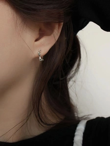 Minimalist 925 sterling silver wavy curved stud earrings with a glossy metallic finish